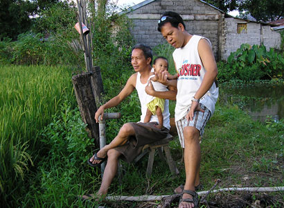 The writer with Gimel and Ramil -- relaxing on the farm.